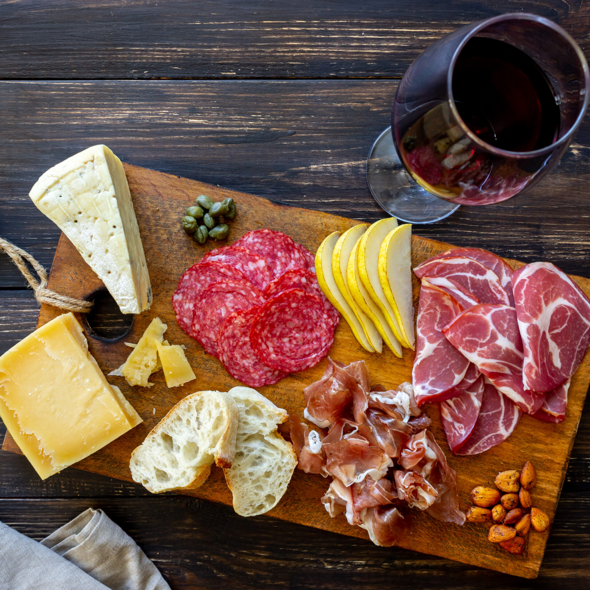 Wine snack. Prosciutto, Parma ham, salami, almonds, olives, baguette, blue cheese, parmesan. Antipasti. Wine snack. Prosciutto, Parma ham, salami, almonds, olives baguette blue cheese parmesan Antipasti